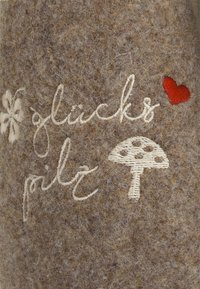 Brown felt fabric with white and red embroidered text "glückspilz" and a small mushroom design. Texture is soft and fuzzy.