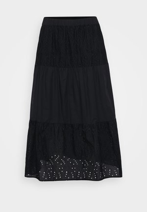 Zwarte gelaagde rok met geborduurde bovenlaag, textuur onderaan en geperforeerde details nabij de zoom. Elastische tailleband voor comfort en een goede pasvorm.