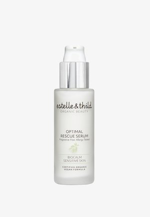 Bottiglia di siero in vetro satinato con tappo a pompa argento. L'etichetta presenta testo scuro su uno sfondo chiaro, indicando ingredienti senza fragranza e biologici.