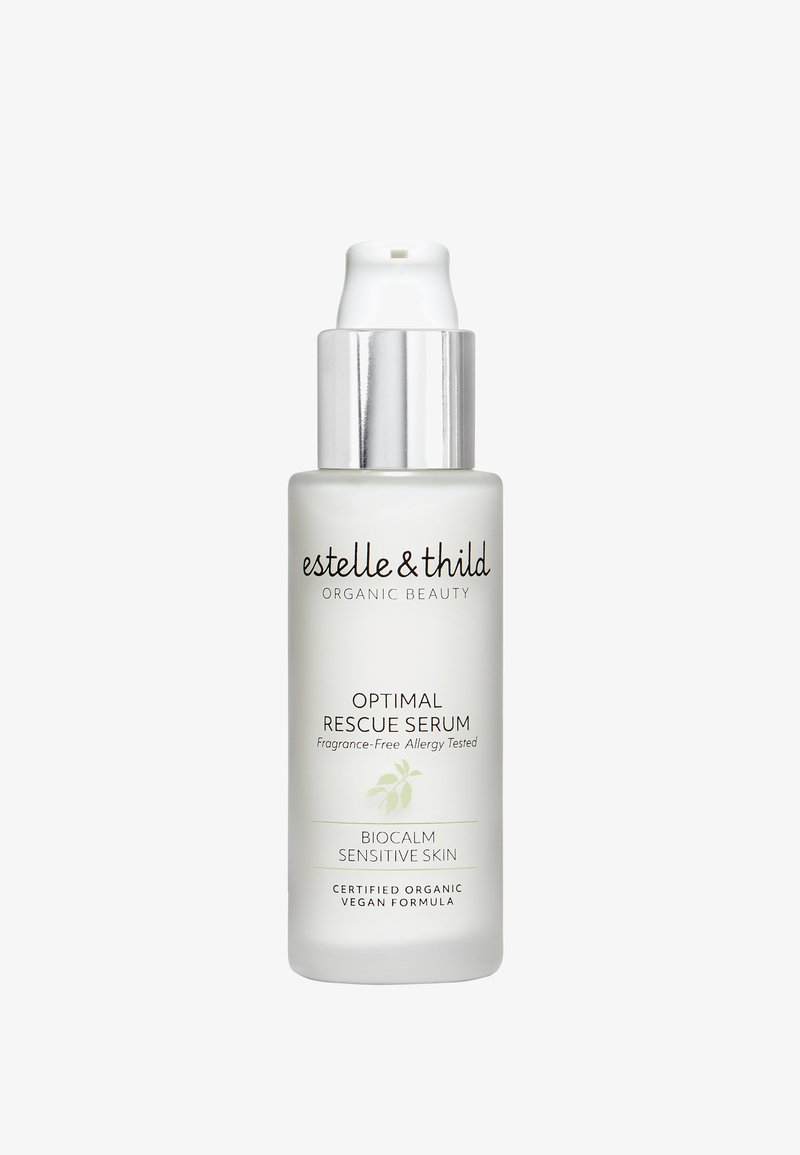 Frostet glass serumflaske med en sølvfarget pumpekork. Etiketten har mørk tekst på en lys bakgrunn, som indikerer at produktet er uten duft og inneholder organiske ingredienser.