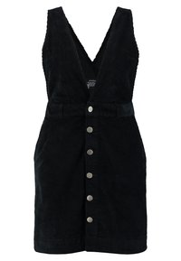 Schwarzes Cordkleid mit tiefem V-Ausschnitt, ärmellosem Design, Knopfleiste vorne und tailliertem Gürtel. Die Textur ist gerippt und weich.