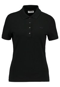 Polo noir en coton, avec un col classique, patte de boutonnage à trois boutons, manches courtes et un logo Lacoste discret sur la poitrine.