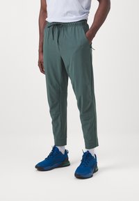 Nike Performance UNLIMITED PANT - Treningo apatinė dalis - vintage green/black
