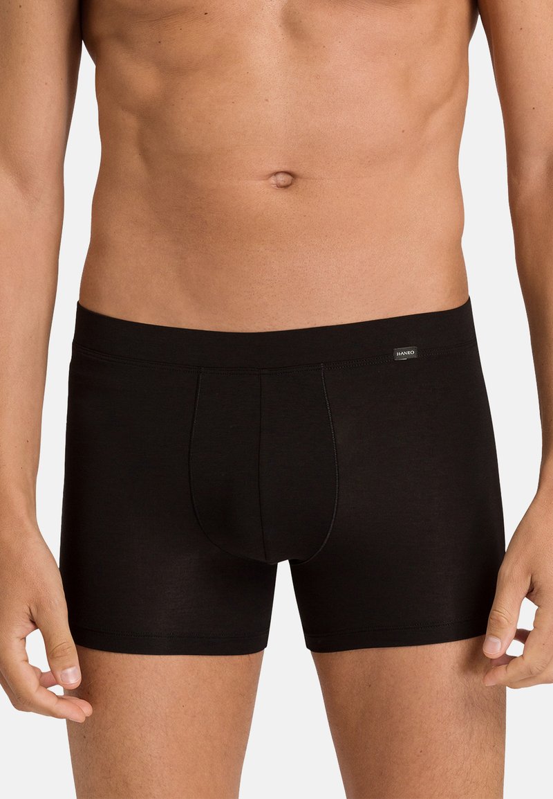 Black boxer shorts made of smooth fabric, featuring a snug fit, elastic waistband, and a front pouch design. No visible patterns or accents.