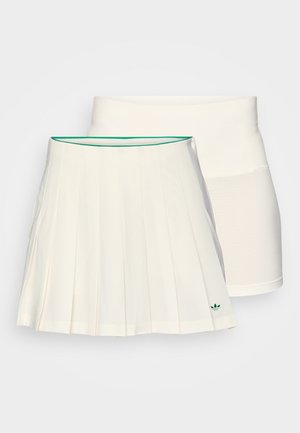 Valge pleeditud seelik rohelise äärise ja logoga, kihiline valge sobiva aluslühikesega, mõlemad kerge kangaga.