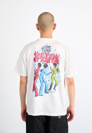 White t-shirt featuring a colorful graphic on the back with three dancing figures in red, blue, and green. Text above reads "the new originals."