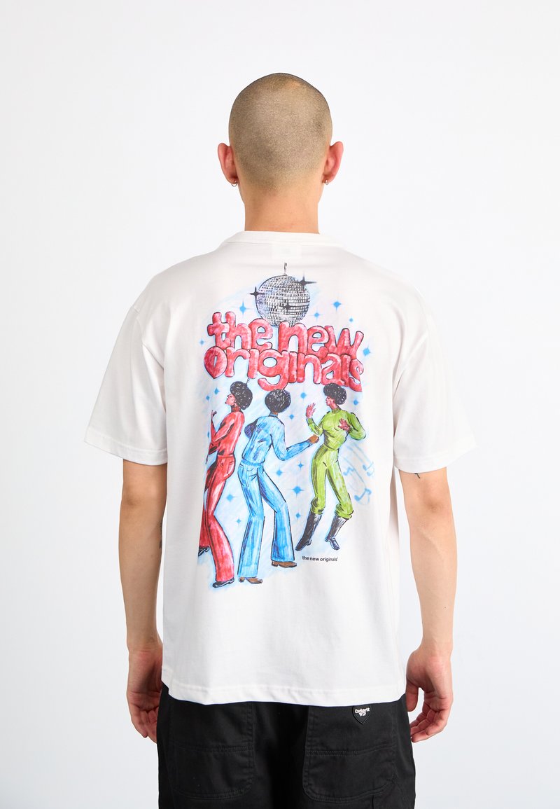 White t-shirt featuring a colorful graphic on the back with three dancing figures in red, blue, and green. Text above reads "the new originals."