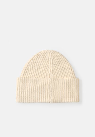 Gorro de malha em tom creme com textura canelada e rebordo dobrado, apresentando um topo liso e sem costuras.