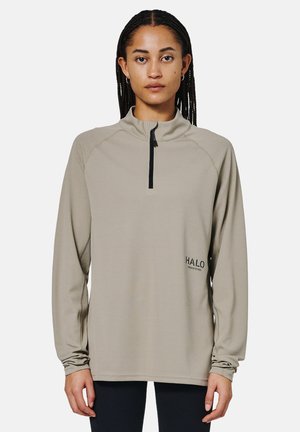 Beige long-sleeve pullover with a quarter-zip neckline, mesh texture, and a subtle logo on the left side. Features relaxed fit and gathered cuffs.