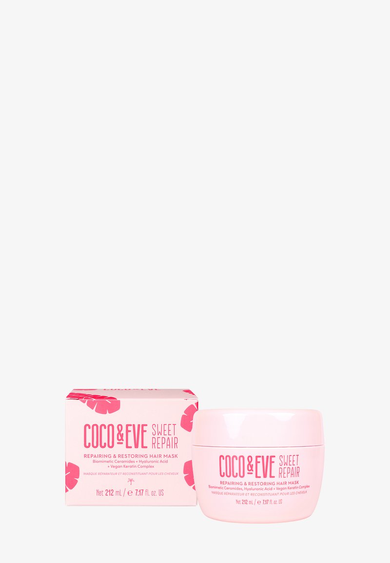 Coco & Eve Sweet Repair hårmask i en rund rosa burk med glansig yta. Boxen visar ett rosa blommönster, produktinformation i fet stil.