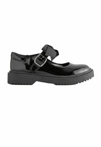Chaussure Mary Jane en cuir verni noir avec semelle épaisse, boucle argentée et nœud en tissu noir sur la bride, vue de côté sur fond blanc.