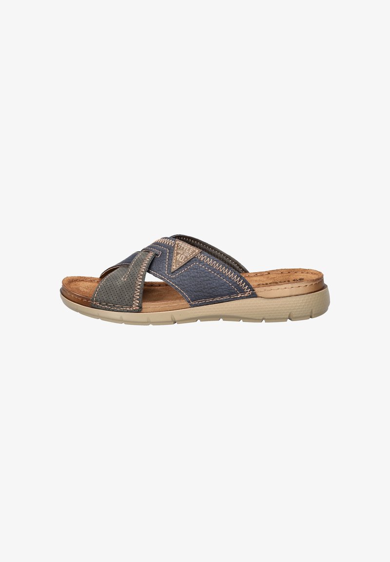 Slide sandal in dark blue and green leather with cross-strap design, textured accents, and a light tan rubber sole. Features cushioned footbed.