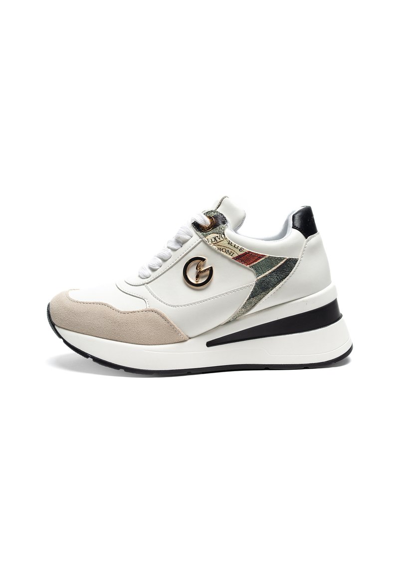Sneaker bianca con dettagli in suede beige, pannello laterale testurizzato, tallone nero e logo metallico. Presenta lacci piatti e una suola spessa.