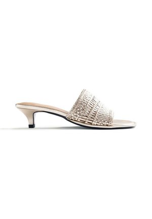 Sandalia mule beige de punta abierta con tacón bajo de aguja y tira texturizada trenzada sobre el pie, vista de perfil sobre fondo blanco.