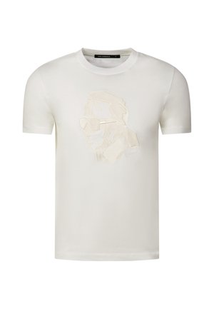 T-shirt blanc à manches courtes, col rond, avec un subtil contour en relief du visage d’un homme portant des lunettes de soleil sur la poitrine.