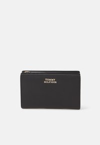 Black wallet made of smooth leather, featuring a gold logo on the front and a zip closure. Rectangular shape with clean lines.