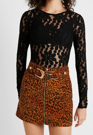Black long-sleeve sheer lace top with floral patterns paired with a high-waisted brown leopard print mini skirt featuring a gold buckle belt and zipper.