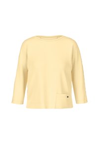 Yellow three-quarter sleeve top made of soft material, featuring a round neckline, a side pocket, and a small decorative metal accent.