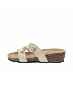 Sandales compensées beiges dotées de deux boucles réglables, d'une semelle en liège et d'une semelle extérieure en caoutchouc texturé. Des brides croisées pour un soutien et un confort optimaux.
