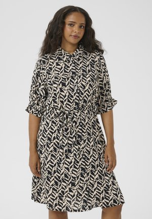 Robe à manches courtes, boutonnée, en beige et bleu marine avec un motif en zigzag. Dotée d'une taille cintrée et d'une coupe jusqu'au genou avec des manches plissées.