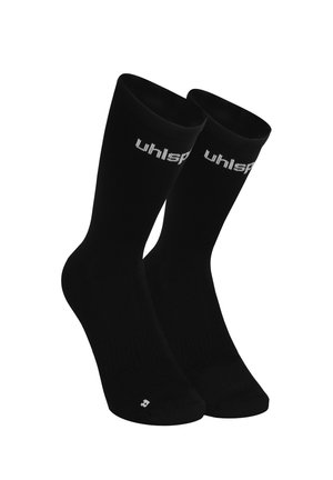 Paar schwarze Sportsocken bis zur Mitte der Wade mit weißem "uhlsport"-Logo nahe dem oberen Rand und kleinem "R" im Bereich der rechten Zehe.