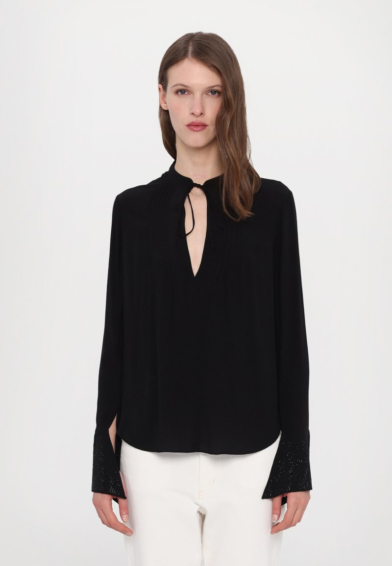 Black long-sleeve blouse with a keyhole neckline, textured pleats, and embellished cuffs. Lightweight fabric with a flowing design.