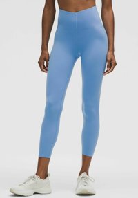 High-waisted, form-fitting leggings in light blue, made of stretchy material. Features a smooth texture and cropped ankle length.