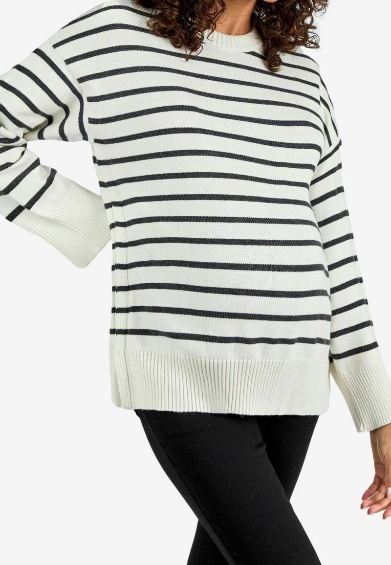 Maglione a righe bianche e nere con polsini e orlo a costine. Maniche lunghe e vestibilità comoda, realizzato in un morbido materiale a maglia.