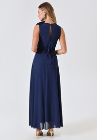 Nachtblaues, A-Linien Abendkleid mit ärmellosem Design, Rücken-Schlüsselloch, gebundenem Taillendetail, fließendem Saum und transparenter Textur.
