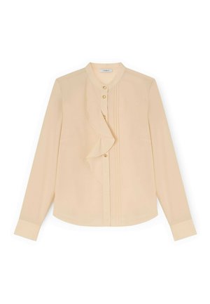 Blusa beige a maniche lunghe con dettaglio di volant lungo la patta dei bottoni e piccoli bottoni dorati, caratterizzata da scollo rotondo e maniche con polsini.