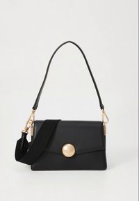 Black leather handbag with a smooth texture, a gold circular clasp, and a detachable strap featuring textile accents. Compact rectangular design.