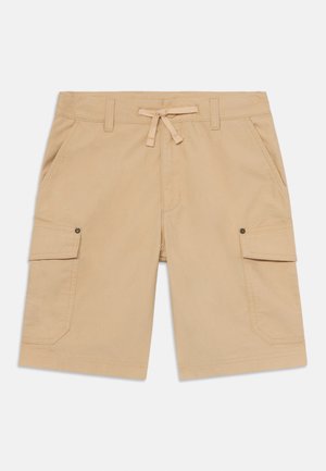 Calças de trabalho em bege com um cós ajustável, dois bolsos laterais e dois bolsos frontais. Feitas de um tecido leve com uma textura suave.