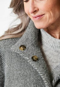 Grau Wollmantel mit einem strukturierten Muster, ausgestattet mit einem weiten Kragen und zwei großen braunen Knöpfen am Hals. Weicher, gemütlicher Stoff.