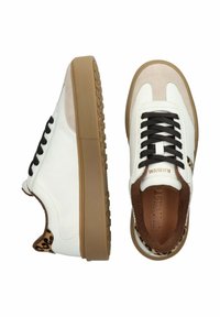 White and beige low-top sneakers with black laces, brown gum soles, and leopard print accents on the heel and collar lining.