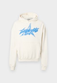 Sudadera crema con bolsillo frontal, presenta un gran gráfico de estrella azul con texto. Fabricada en tejido suave con un ajuste relajado y puños acanalados.