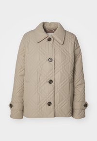 Beige quilted jacket with large collar, diagonal stitching pattern, four buttons, and side pockets. Made from soft, textured fabric.
