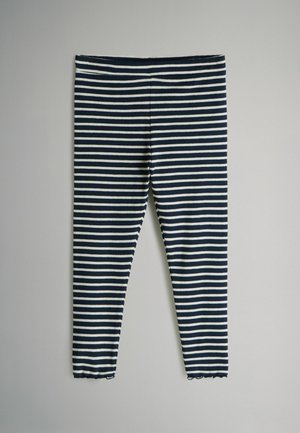 Randiga leggings i marinblått och vitt, tillverkade av ribbat tyg. Har en åtsittande passform och en scalloped fåll vid vristen.