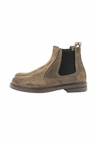 Stivaletti in suede marrone con pannelli elastici ai lati, punta rotonda e una linguetta sul retro. Suola piatta in gomma con il minimo battistrada.