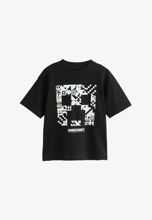 Musta puuvillane T-särk, millel on valge pikselkunstiga graafika, millel on Minecrafti elemendid. Lühikesed varrukad ja ümardatud kaelus.