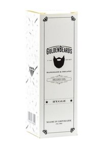 Förpackning av skäggolja, vit med svart text och illustrationer. Utmärks av en diamantdesign och streckkod. Märkt "Hygge," 30ml. Tillverkad i Danmark.