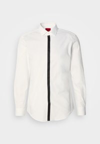 Witte longsleeve shirt met een zwarte verticale streep in het midden. Beschikt over een klassieke kraag en knoopsluiting. Gemaakt van een zachte katoen stof.