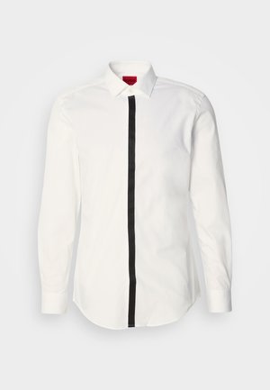 White long-sleeve shirt with a black vertical stripe down the center. Features a classic collar and button closure. Smooth cotton fabric.