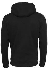Felpa nera con cappuccio realizzata in morbido cotone misto. Presenta maniche lunghe, polsini a costine e una vestibilità casual e rilassata.