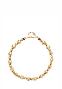 Collier de perles en or composé de perles sphériques polies de tailles variées. Comprend des accents en caoutchouc noir et un fermoir avec une chaîne de rallonge.