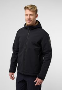 Veste noire avec capuche, en matériau doux. Elle présente une doublure en fausse fourrure autour du cou, une fermeture éclair et un logo sur la manche.