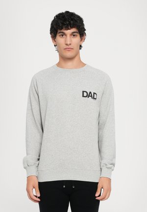 Gray sweatshirt featuring a crew neck and long sleeves. Includes a black printed "DAD" logo on the left chest pocket area. Smooth texture.