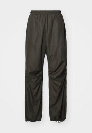 Ciemnoszare, lekkie, wodoodporne spodnie z elastycznym pasem, regulowanymi mankietami i bocznymi kieszeniami; gładkie wykończenie i luźny krój.