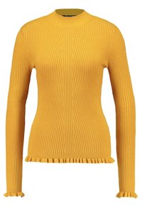 Keltainen ribbineuleinen paita, jossa on korkea kaulus, pitkät hihat ja röyhelöhelma. Neuleessa on pystysuorat raidat ja se on tiukka päällä.