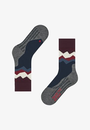 Pair of mid-calf socks with grey toes and heels, navy blue with red, white, and blue mountain pattern and red text on sole and cuff.