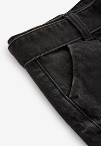 Melni denimu bikses ar salocītu jostasvietu, redzamu kabatu un smalku tekstūru ar kontrastējošu šuvju detaļu.